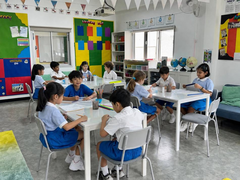 Key Stage 2 Year 6 students discussing their work together