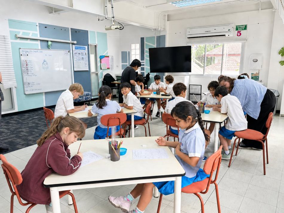 A student writing at his desk during a lesson