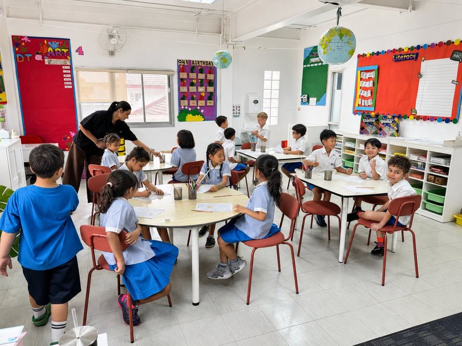 Students doing a colouring activity together at a round table