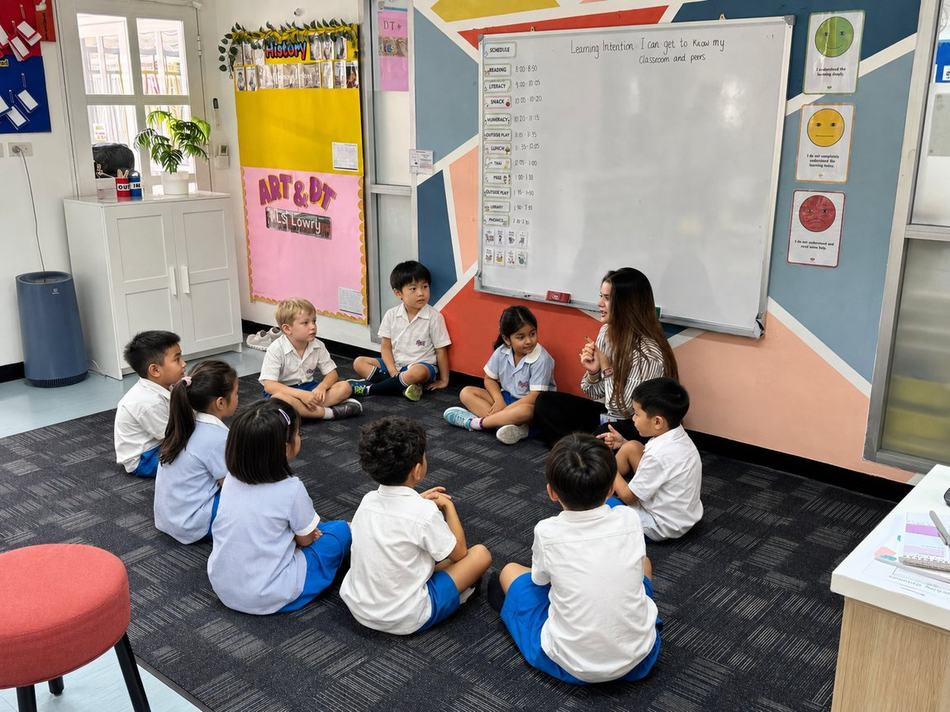 Year 2 students sitting together on the carpet during a lesson