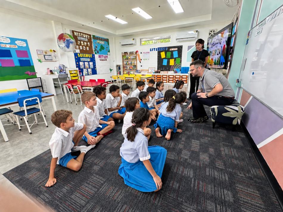 Key Stage 1 Year 2 students following a lesson at the whiteboard