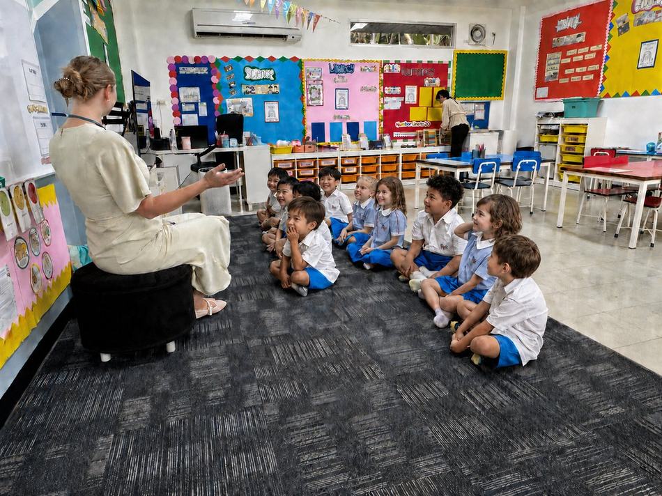 Students sitting together listening to their teacher during storytime