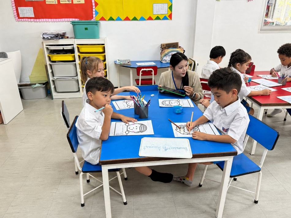 Students colouring together at their table