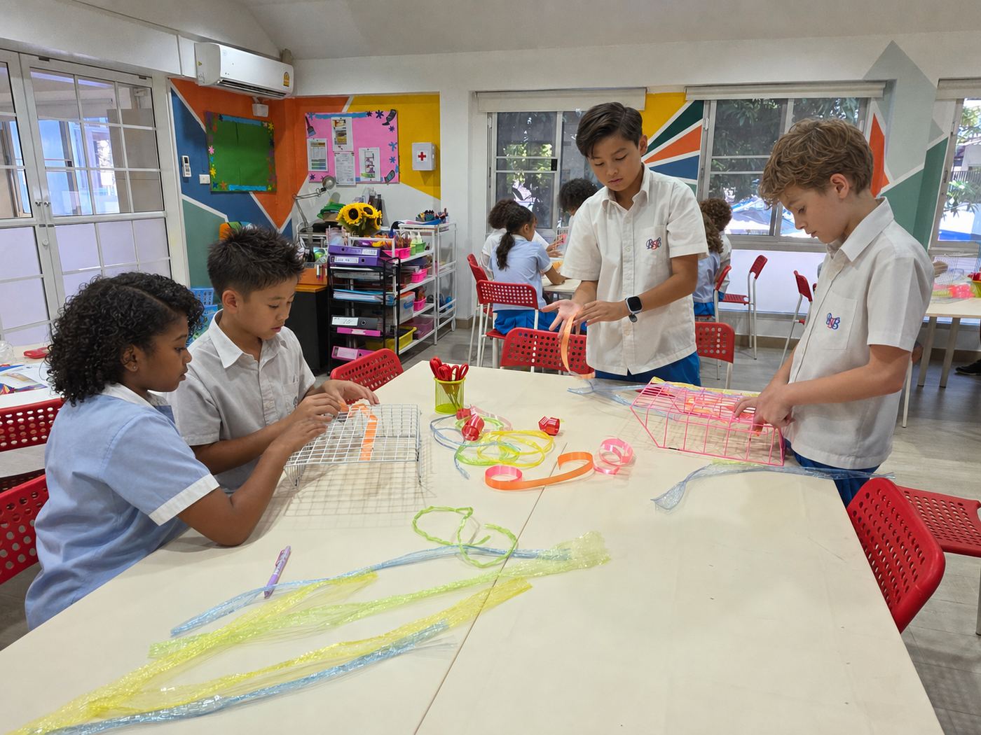 Students building a wire-frame lantern craft