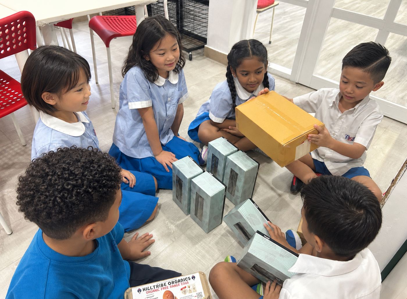 Students unboxing materials for a design and technology project