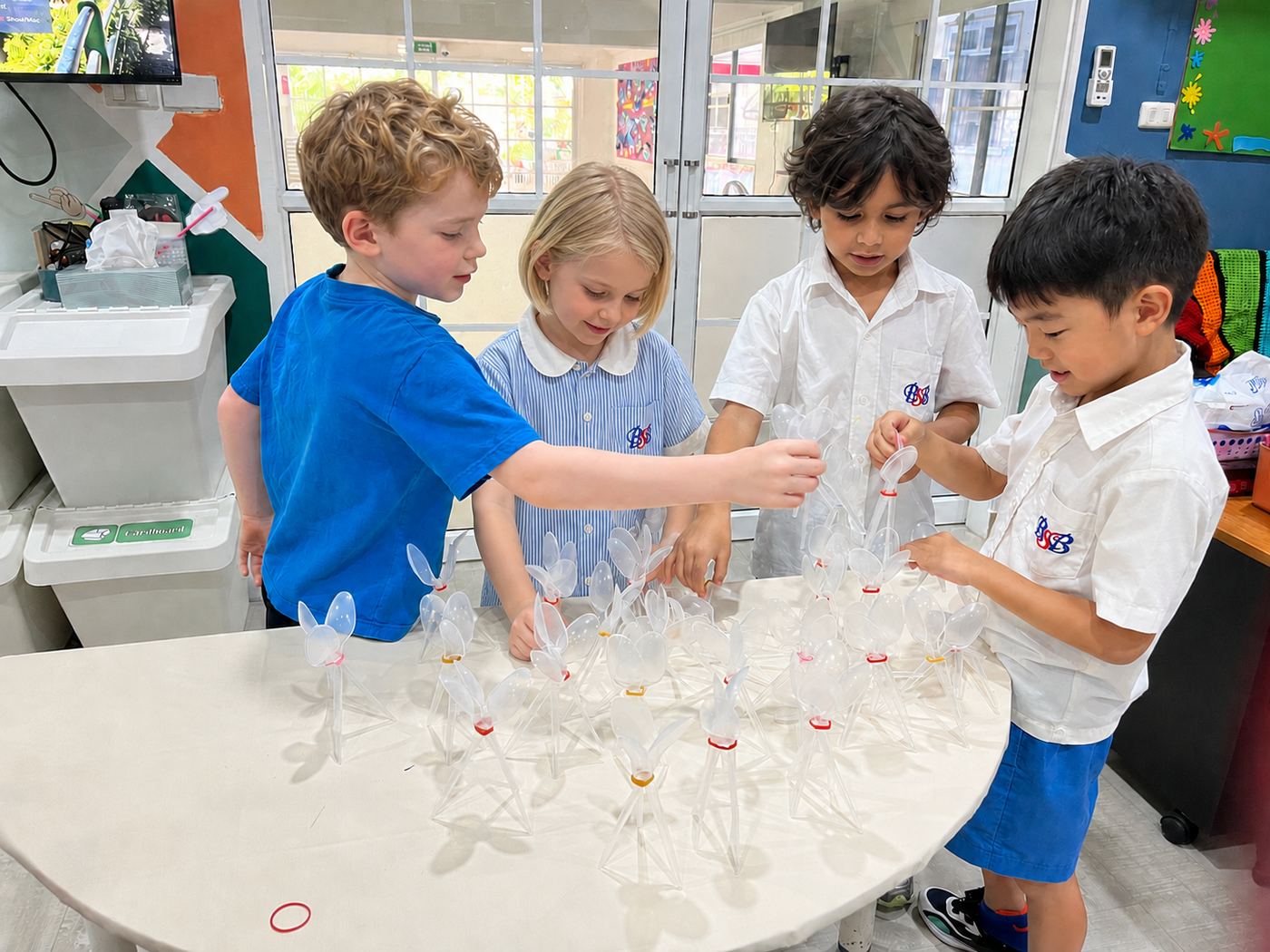 Students building a pinwheel craft together