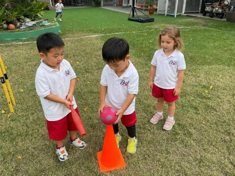 Students practising a target toss with a coach during Ball Skills