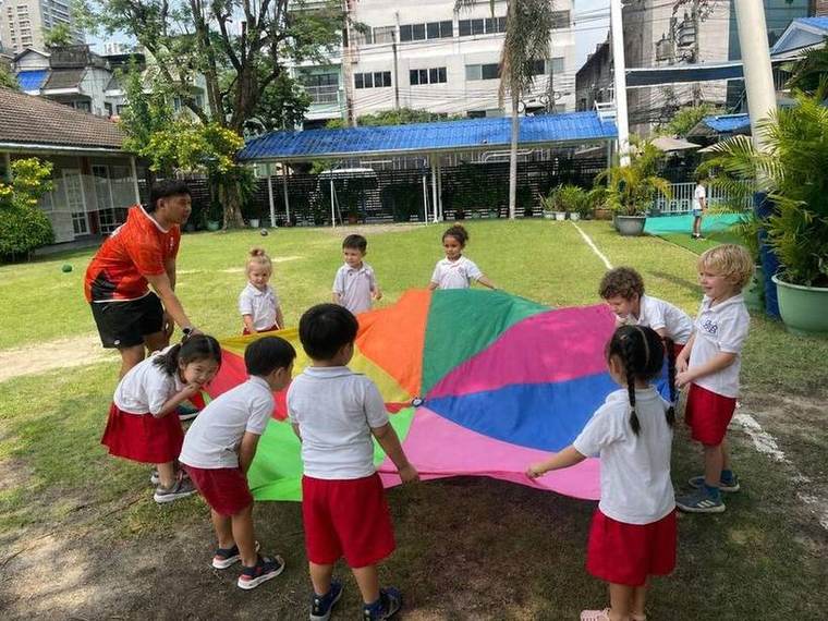 Students playing a parachute game together during Ball Skills