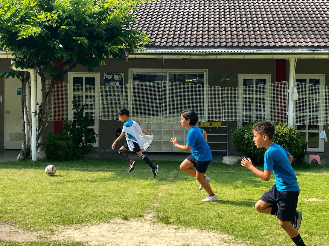 Students practising football drills during Football Club