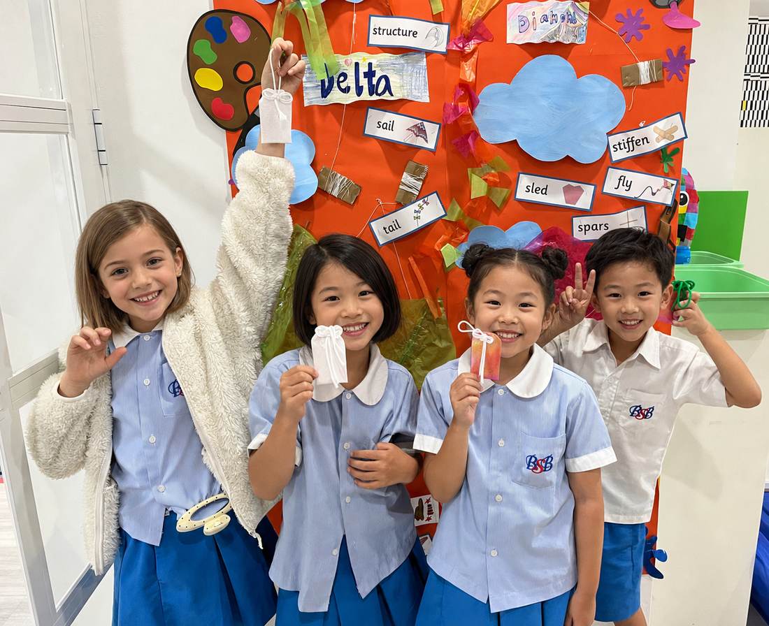 Students showing off their folded paper crafts during Origami