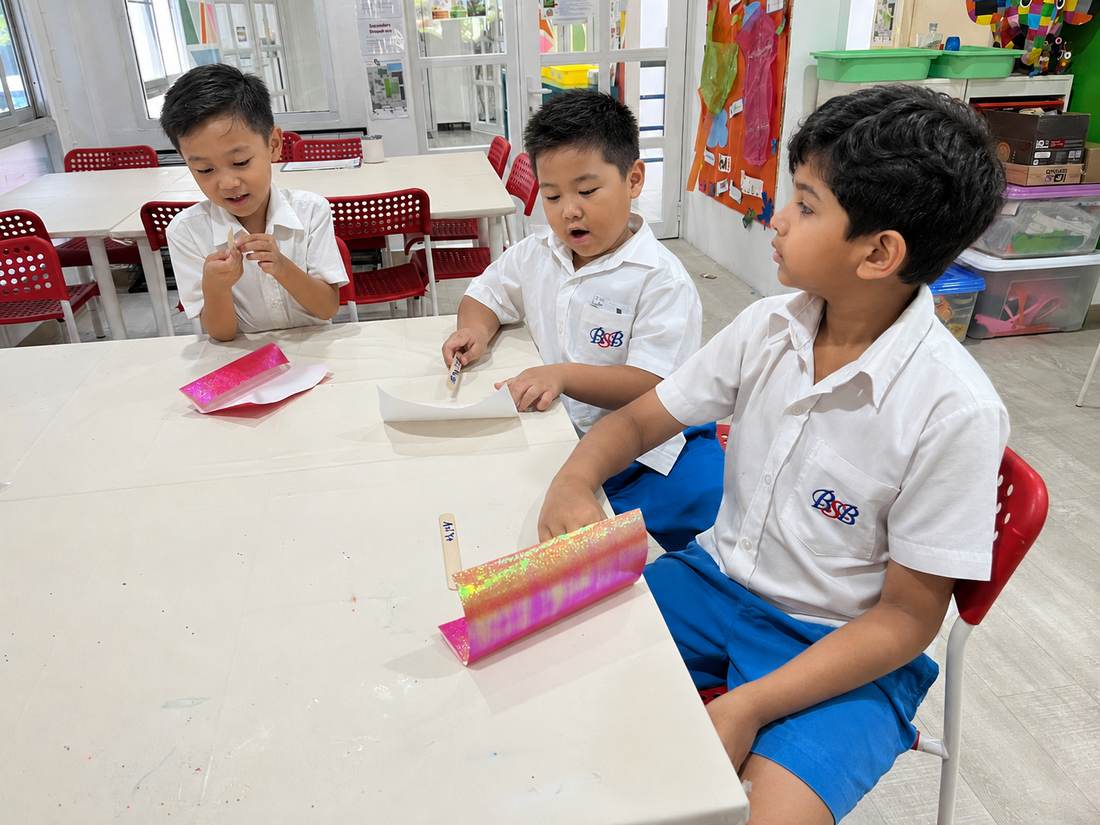 A student working on a paper craft during Origami