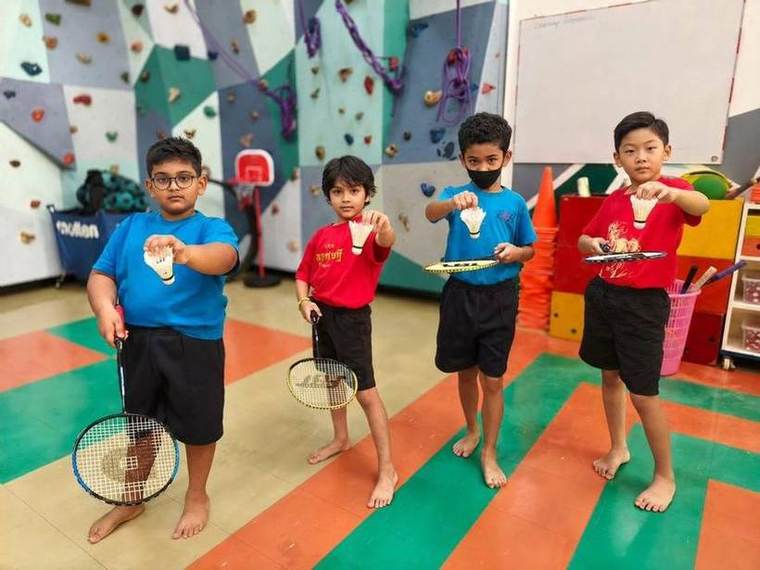 Students holding their rackets and shuttlecocks together during Racket Skills