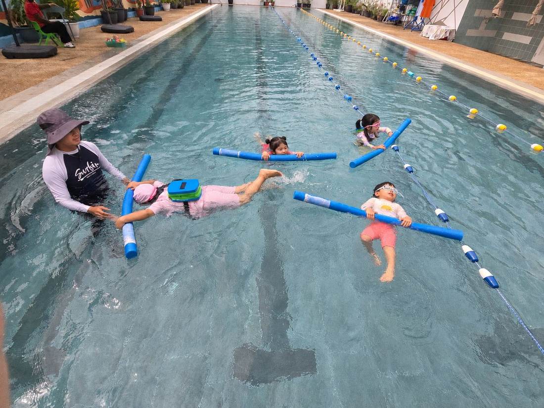 Students practising strokes at the pool during Swimming Club