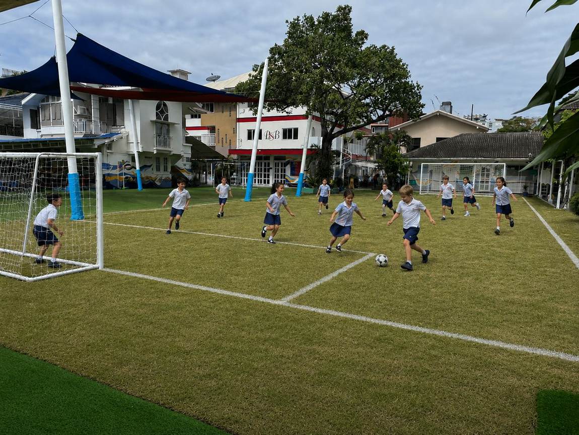 Students playing football on the school field