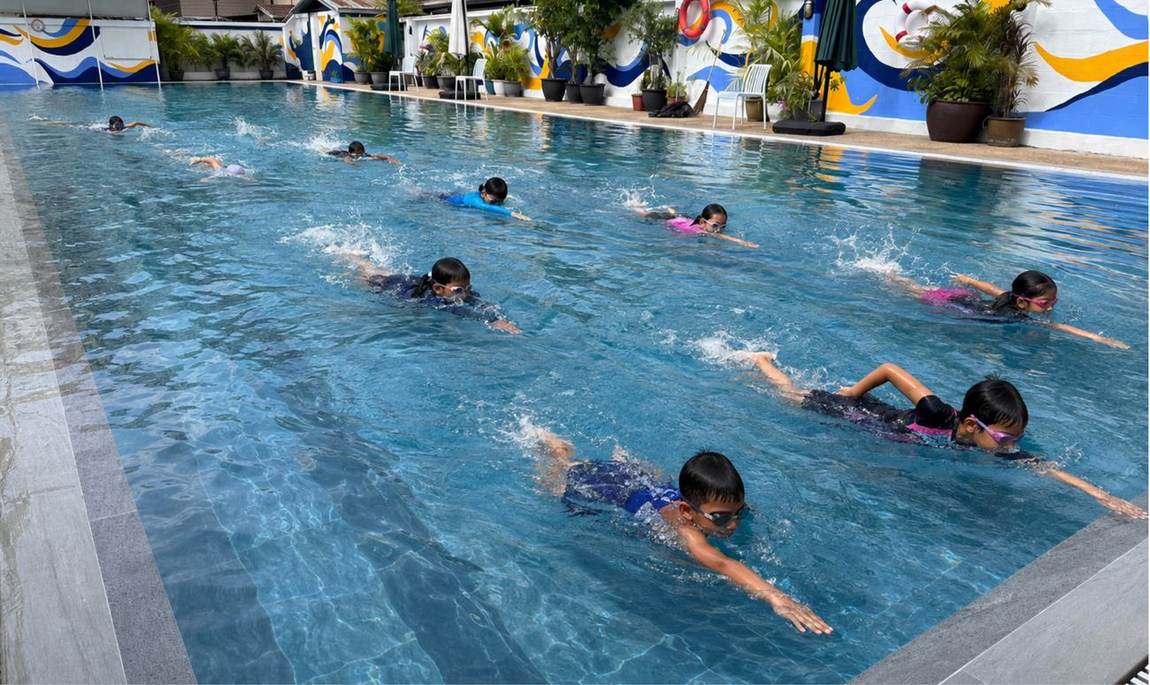 Students swimming laps in the school pool