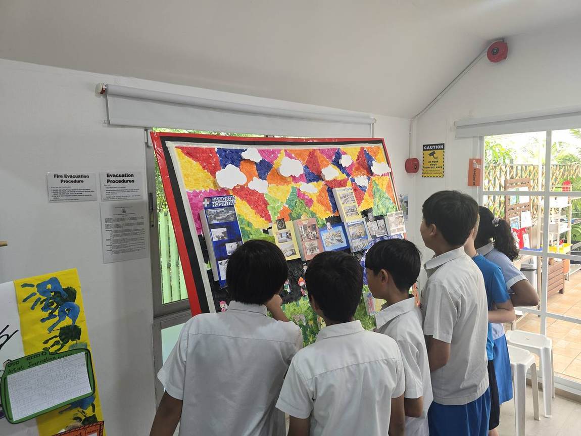 Students standing beside their finished artwork at the Art Gala