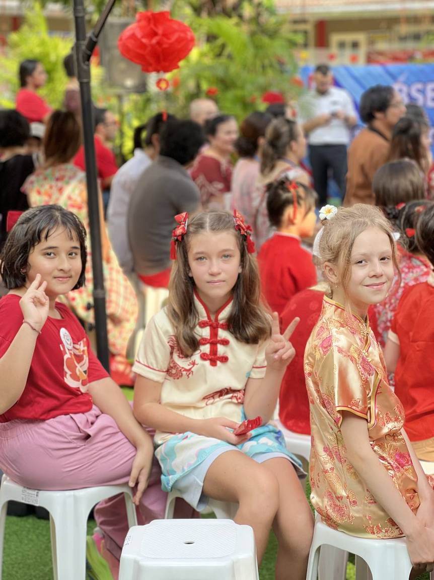 Students in traditional dress with the lion dance performers