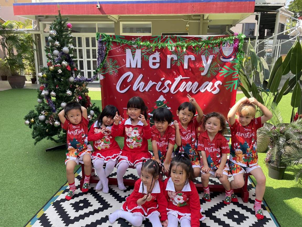Foundation Stage class group photo in front of the Christmas Show backdrop