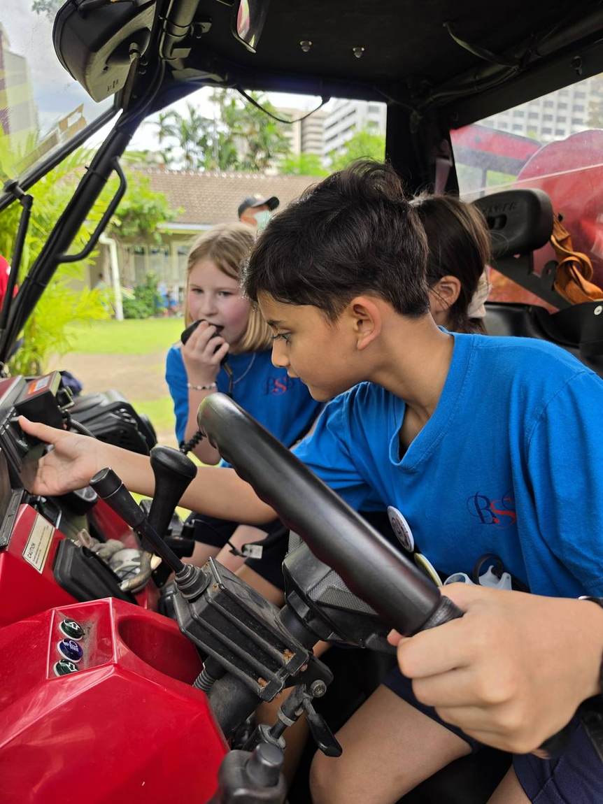Students helping spray a fire hose at the Fireman Show