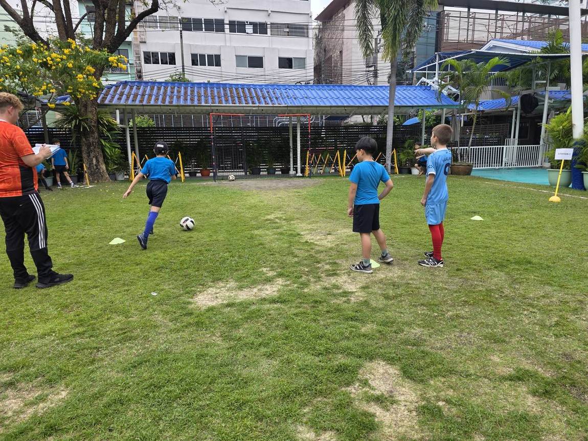 Students playing football on the school field during try-outs