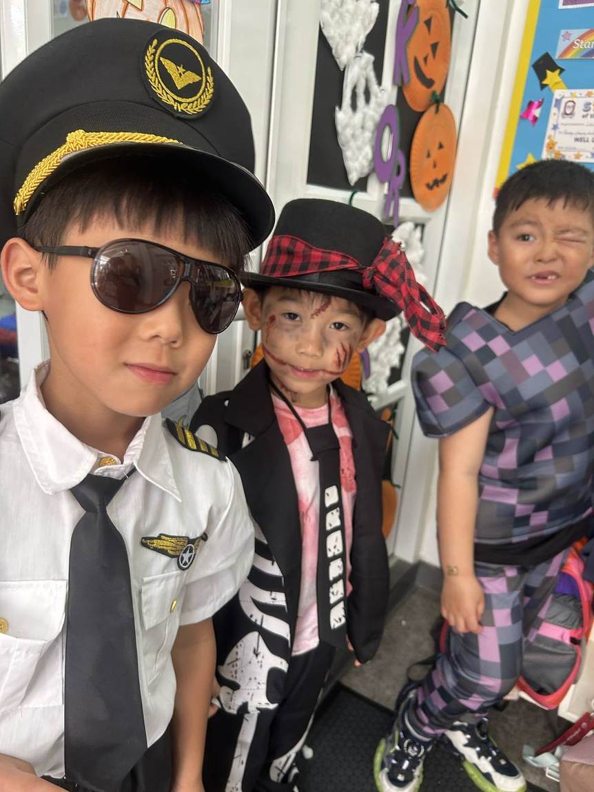 Boys dressed as a pilot, pirate and skeleton for Halloween