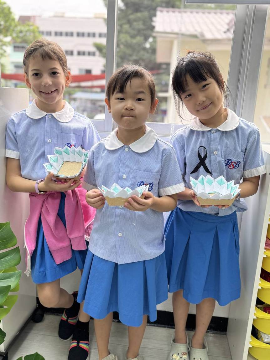 Students holding handmade krathongs on Loy Krathong Day