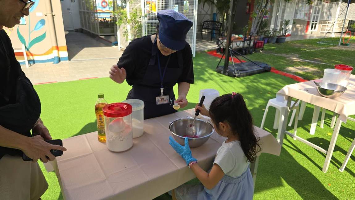 Staff welcoming visiting families at Open Day