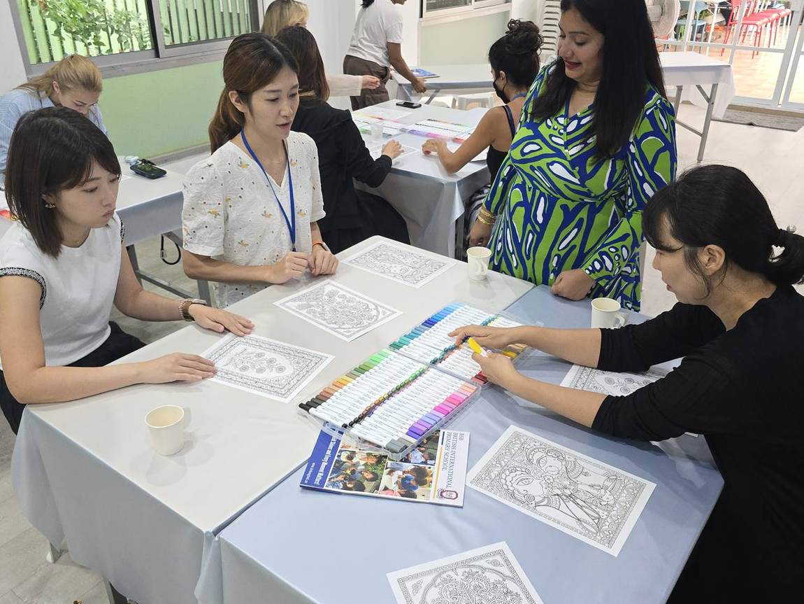 A parent working on a colouring piece at the Parents' Art Workshop