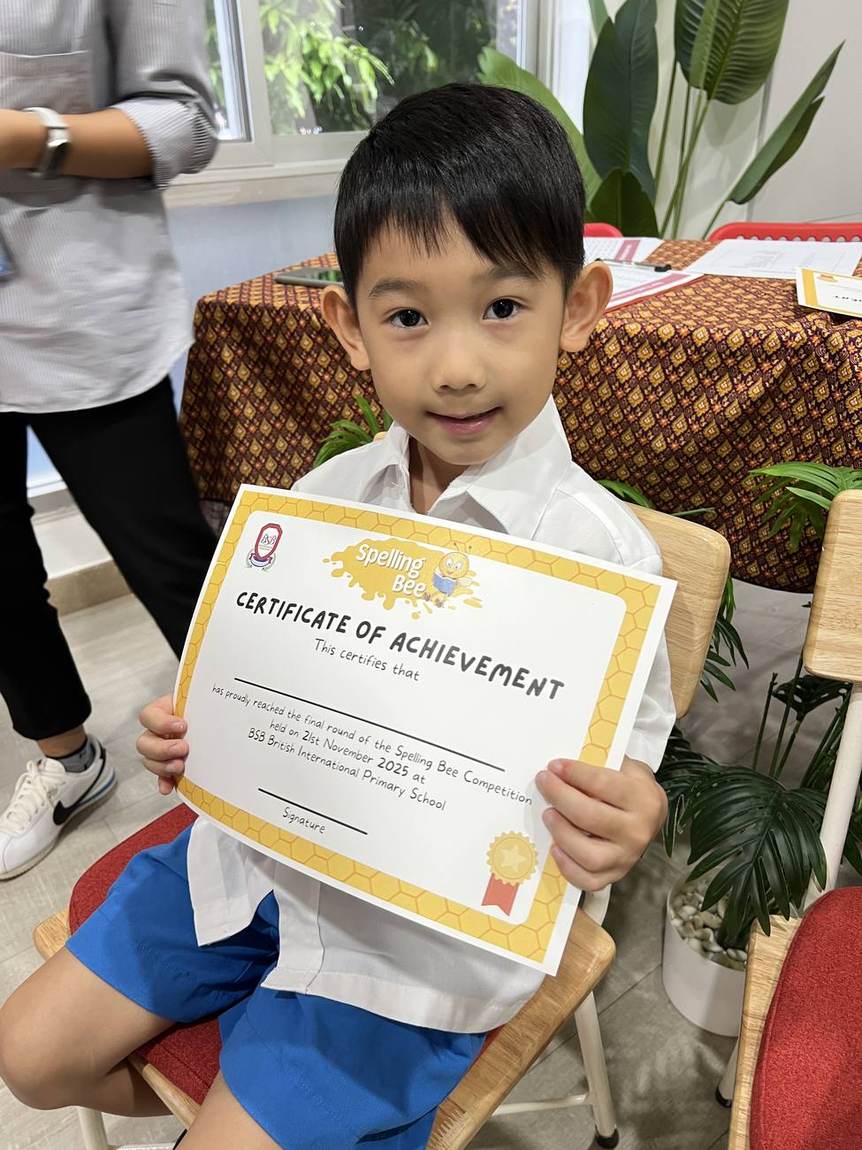 A student holding his Spelling Bee certificate of achievement