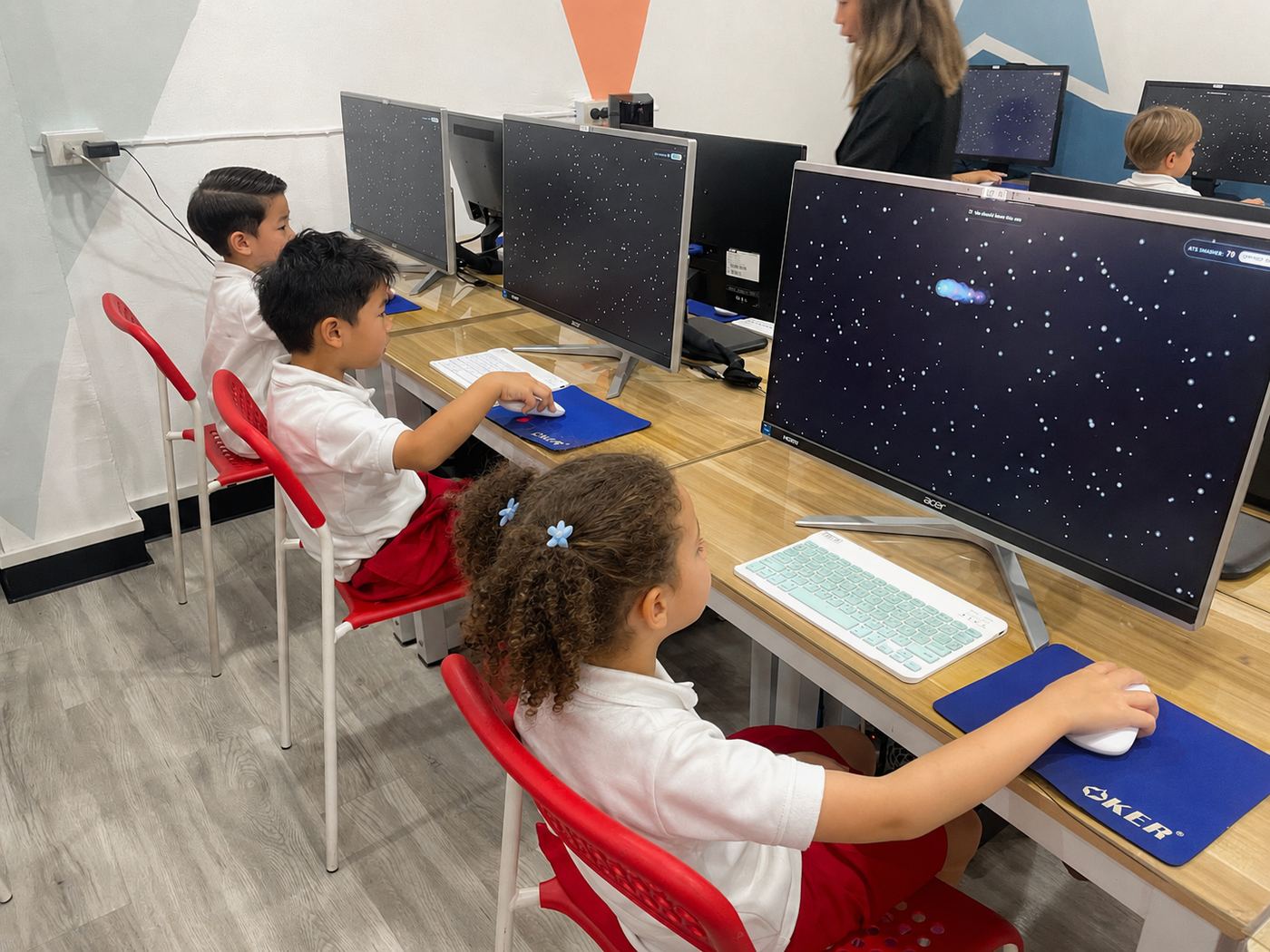Students playing an educational game together on the computers