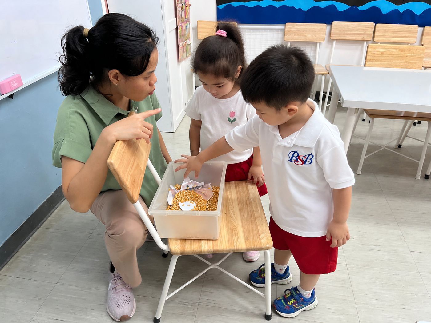 A teacher and young students exploring Thai vocabulary together