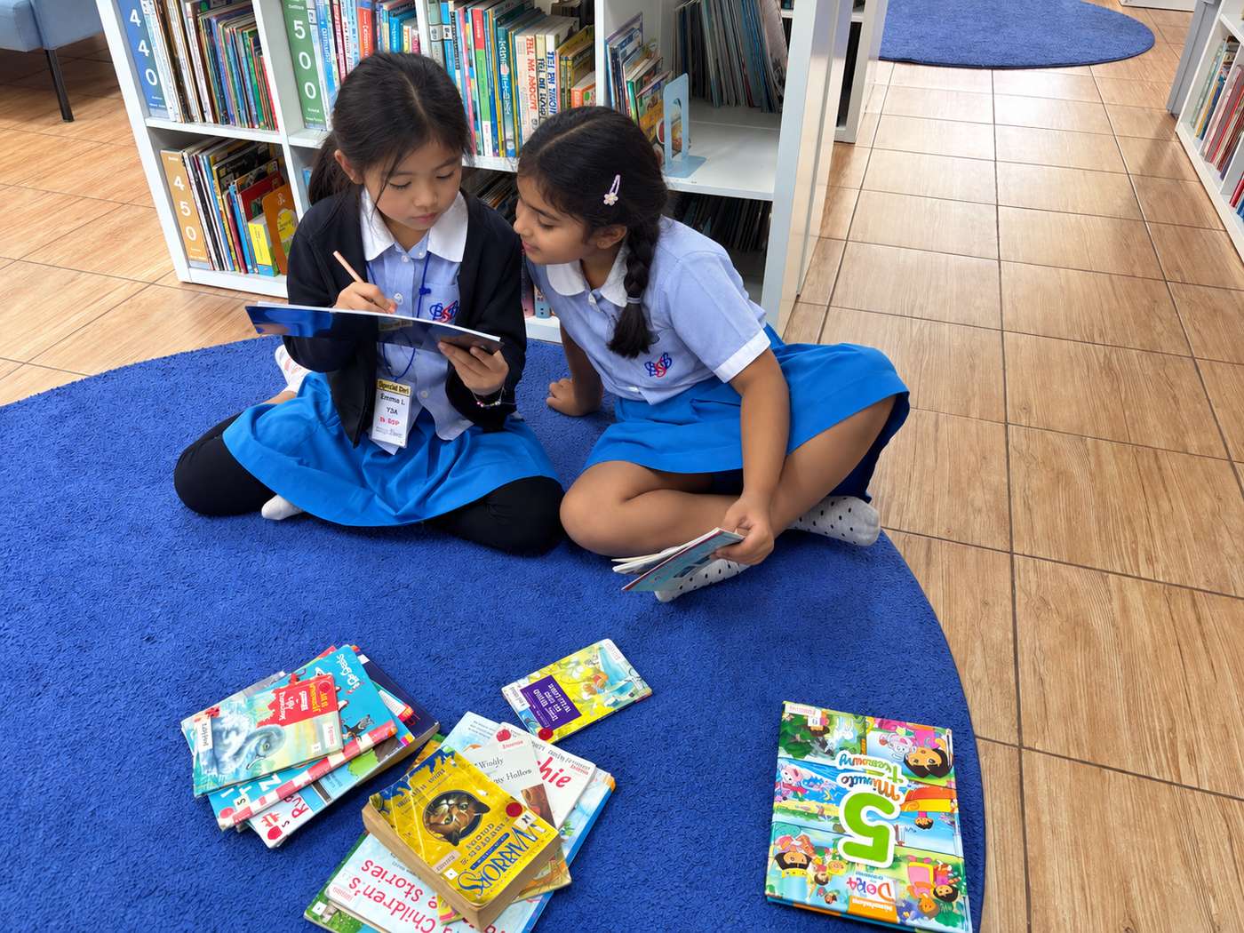 Library Helpers sorting and organising books together