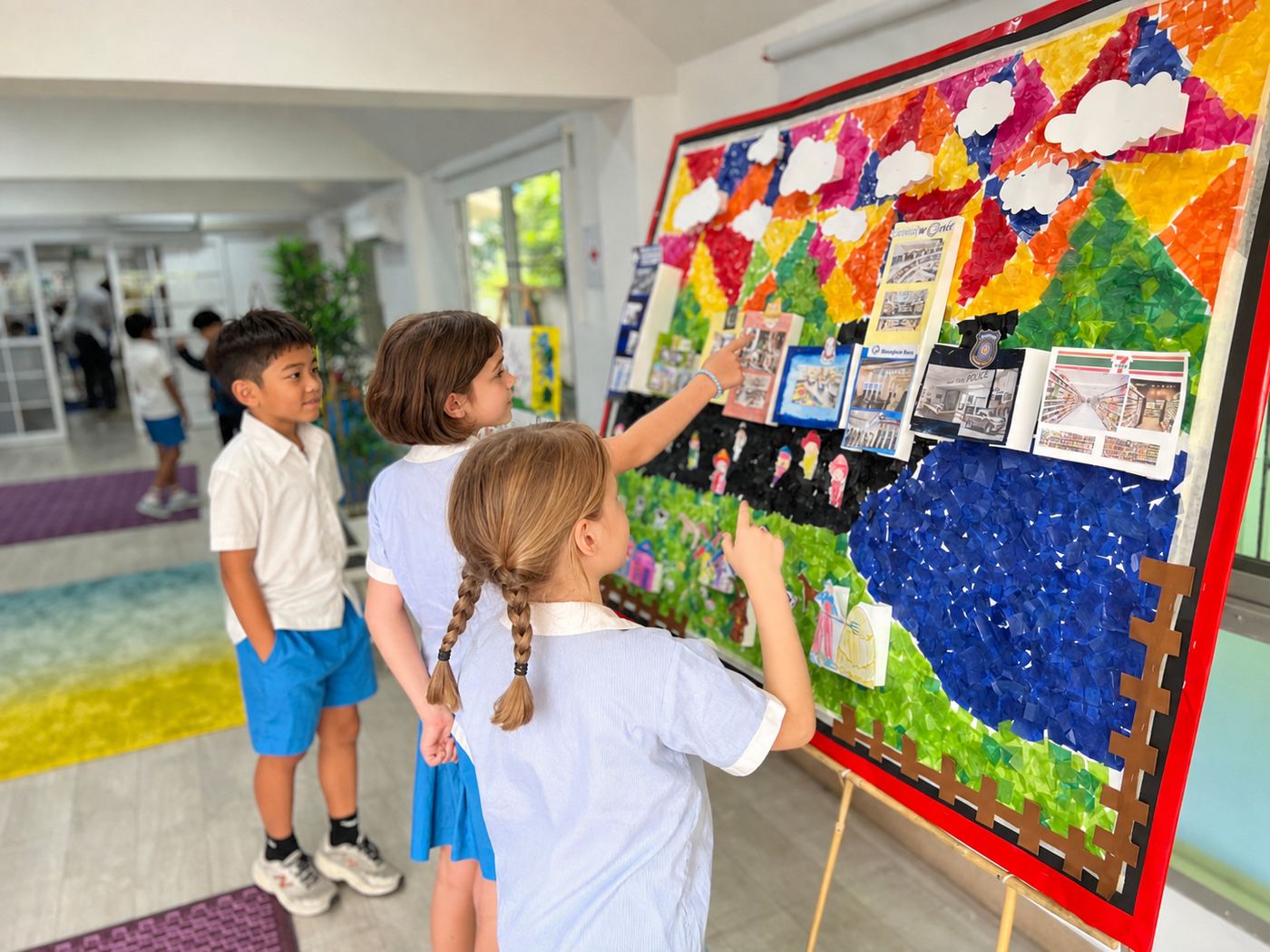 Students examining a collaborative class display board