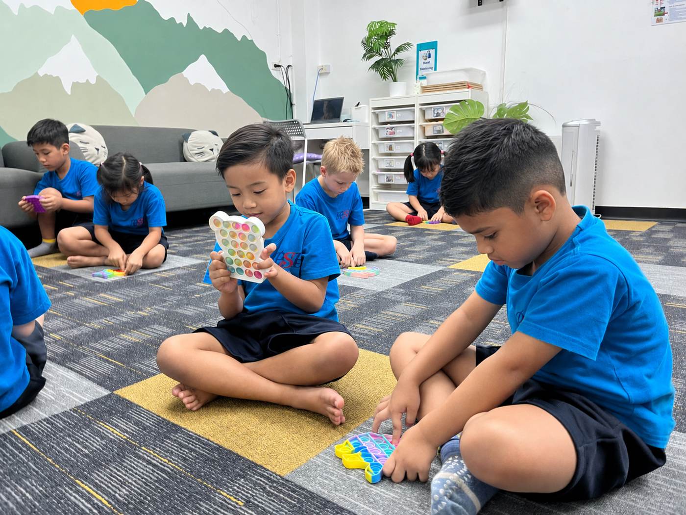 Students exploring pop-it sensory toys in the calming room
