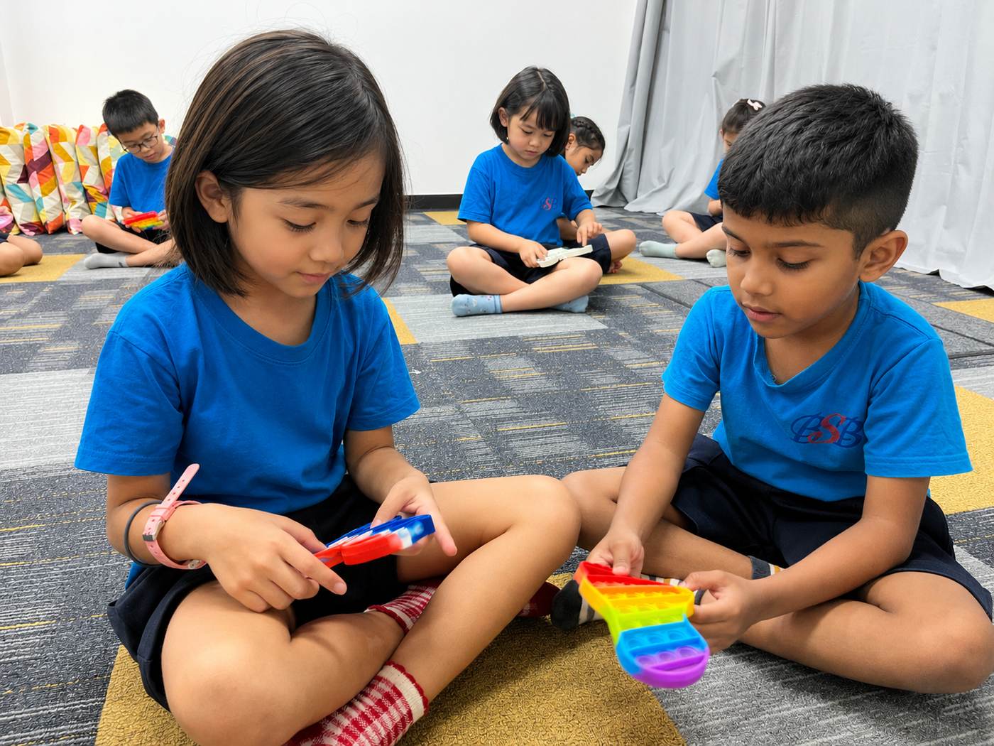 Two students exploring fidget toys together